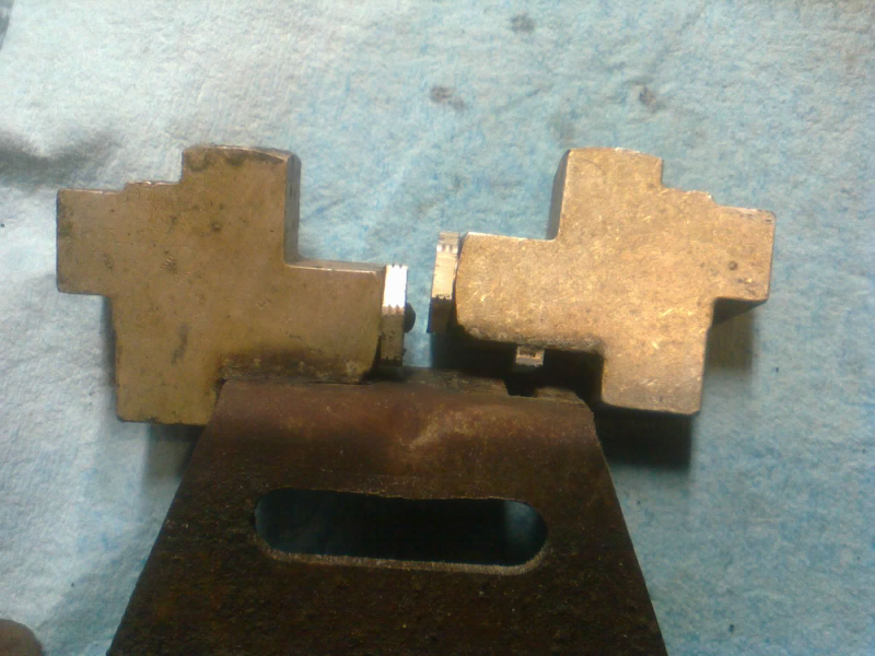 Luckily, the plugs face each other so closely that the caps never fell out the rest of the way. Before disassembly, the little black caps were touching. But here, I’ve re-assembled the right block, and the cap sits in a recess of the plug, where you can’t see it.